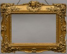 A 19th century carved giltwood and gesso frame Of serpentine outline, worked with hunting motifs.