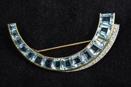 A 14K gold, diamond and aquamarine brooch Of curved spray form. 6 cm wide.