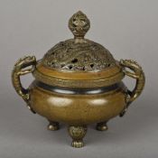 A Chinese cast bronze twin handled censor and cover The cover pierced,