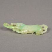 A Chinese carved green and celadon jade Buddha's finger 11 cm long.