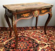 A 19th century marquetry inlaid walnut card table The shaped hinged revolving top centred with a
