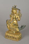 A Chinese gilt bronze model of a four armed deity Modelled in the lotus position,