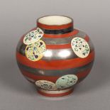A Japanese pottery Art vase Of bulbous form, the banded decoration incorporating floral roundels,