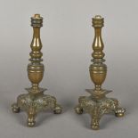 A pair of 17th century Continental bronze candlesticks Each with ring turned stem above the angel