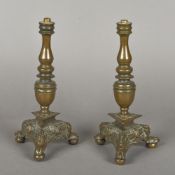 A pair of 17th century Continental bronze candlesticks Each with ring turned stem above the angel