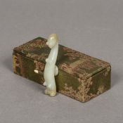 A Chinese carved celadon jade belt hook Typically worked, signed, in fitted box. 8 cm long.