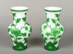 A pair of Chinese Peking glass vases Each worked with floral sprays on a white ground. 19.