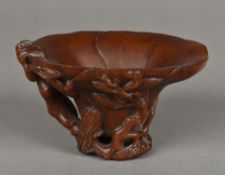 A Chinese carved horn libation cup Worked as a lotus flower. 9 cm high.