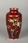 A Japanese white metal mounted cloisonne vase Worked with flowering blossom on a textured red