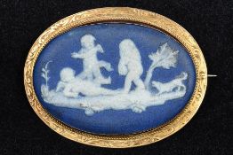 A 9 ct gold framed Wedgwood cameo brooch Decorated with cherubs and a dog. 5.25 cm wide.