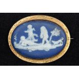 A 9 ct gold framed Wedgwood cameo brooch Decorated with cherubs and a dog. 5.25 cm wide.