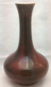 A Sevres flambe pottery vase With all over ox blood glaze, painted marks to base. 31.5 cm high.
