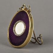 A Russian Faberge style silver gilt paste set and enamelled photograph frame,
