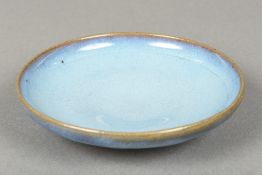 A Chinese Jun-ware porcelain dish With allover mottled blue glaze, standing on a shallow foot.