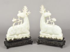 A pair of Chinese carved celadon jade stags Both worked recumbent,