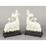 A pair of Chinese carved celadon jade stags Both worked recumbent,