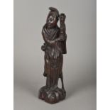 A Chinese carved hardwood wooden figure Modelled standing, in a silver wired decorated robe. 40.