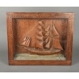 A 19th/20th century carved wood ship diorama Worked in full sail,