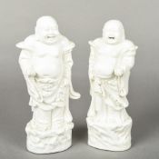 Two Chinese blanc de chine porcelain figures of laughing Buddha Both typically modelled.