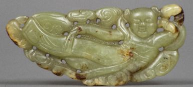 A Chinese carved green and russet jade pendant Worked with an apsra. 8 cm wide.