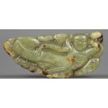 A Chinese carved green and russet jade pendant Worked with an apsra. 8 cm wide.