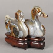 A Chinese carved agate group Worked as two mandarin ducks, standing on a carved wood base.