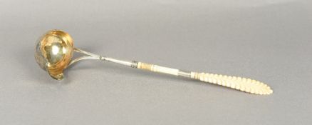 A 19th century Continental ivory handled silver and silver gilt toddy ladle The carved and ring