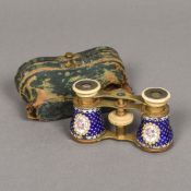 A pair of 19th century cased Swiss enamel decorated opera glasses The eye pieces and finger piece