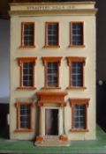 An early Victorian painted dolls house The hinged front inscribed Stratford Villa 1841. 72 cm high.