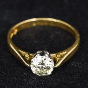 An 18 ct gold diamond solitaire ring The claw set stone spreading to approximately 0.75 carat.