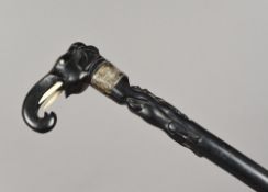 A Colonial ivory and silver mounted carved ebony walking stick,