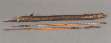 An African tribal hide sheath containing four small hand spears Approximately 48 cm long.