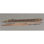 An African tribal hide sheath containing four small hand spears Approximately 48 cm long.