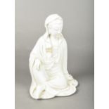 A Chinese blanc de chine porcelain figure of Guanyin Worked seated with one knee raised.