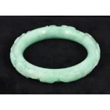 A Chinese carved jade bangle Carved to