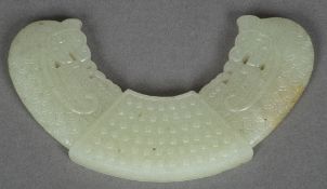 A Chinese carved celadon jade Huang pend