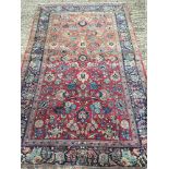 A Persian wool rug The wine red field e