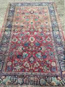 A Persian wool rug The wine red field e