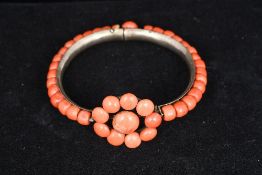 An unmarked white metal coral set bangle