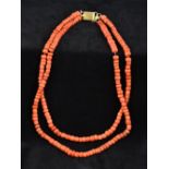 A two strand coral bead necklace