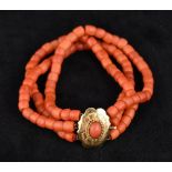 A three strand coral bead bracelet