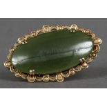 An unmarked gold and jade brooch
