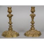 A pair of cast bronze candlesticks Work