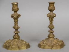 A pair of cast bronze candlesticks Work