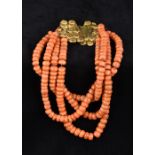 A four strand coral bead necklace