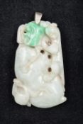 A Chinese carved green and celadon jade