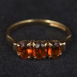 A 9 ct gold three stone fire opal ring