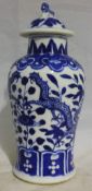 A Chinese blue and white miniature vase and cover,