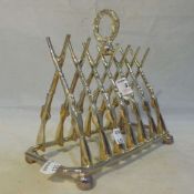 A silver plated gun form toast rack