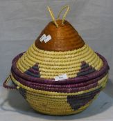 An African hide and woven lidded basket